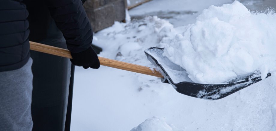 Clearing snow from driveway after heavy winter storm