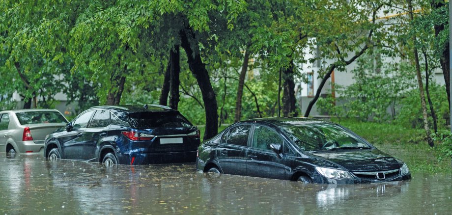 Flooded cars on the street of the city. Street after heavy rain. Water could enter the engine, transmission parts or other places. Disaster Motor Vehicle Insurance Claim Themed. Severe weather concept